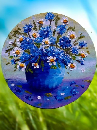 Cornflowers and daisies in a pot